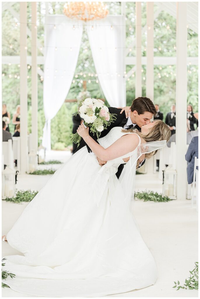 bride and groom's first kiss at camelot manor